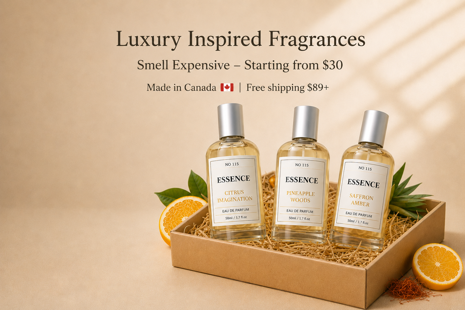 Three bottles of 'Essence' fragrances in a cardboard tray with oranges and leaves on a beige background.